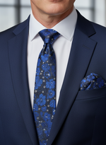 Load image into Gallery viewer, Man wearing a Royal Blue Suit with a blue and white silk floral tie and matching pocket Square. 
