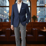 Load image into Gallery viewer, Our Model is wearing a Dark Blue Single Breast, 2 button closure and side vents, notched Lapel Blazer with grey pants and brown shoes 
