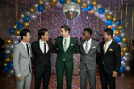 Load image into Gallery viewer, Group of graduates at rom wearing Black, Blue, Charcoal, Forest Green and Blue Forrest Rental Package which includes a 2 Piece Notched Lapel, 2 button closure 2 Piece Slim Fit Suit with White Long Sleeve dress shirt, Tie, Pocket Square and dress shoes. 
