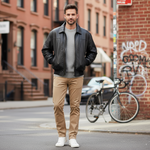 Charger l'image dans la galerie, Our Model is wearing a Classic black genuine leather bomber jacket built to last. Soft sheepskin construction pairs effortlessly with dress pants or jeans for work, weekend, or night out. Removable zippered lining keeps you comfortable year-round. Four functional pockets plus premium leather that ages beautifully. The everyday jacket that works everywhere.
