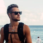 Load image into Gallery viewer, Model is wearing "The Los Angeles Sunglasses, the most popular GOWOOD style. It features legs made of real ebony wood and a front made of acetate. The sunglasses have outward flexible metal hinges for a comfortable fit. All GOWOOD sunglasses provide real protection with their FDA approved and CE certified category 3 high quality lenses. These impact-resistant sunglasses come with a hardwood bamboo storage box for protection, as well as a microfiber pouch for cleaning the lenses."
