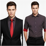 Load image into Gallery viewer, Man wearing a red and black small geometric print long sleeve shirt with contrasting red inside cuffs. Model is wearing a black 2 piece suit with matching red tie and pocket square 

