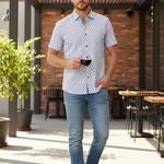 Charger l'image dans la galerie, Man wearing a blue/purple geometric print short sleeved shirt in a casual setting 
