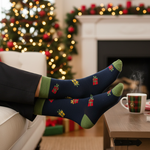 Load image into Gallery viewer, Our model is wearing festive socks against a solid color background in Mustard Yellow, Navy, or Red with a Wrapped Presents pattern. These socks make a great gift for yourself or someone you love during the holiday season.
