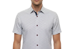 Charger l'image dans la galerie, Man wearing a white multi color geometric patterned short-sleeve shirt 
