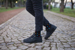 Load image into Gallery viewer, Men's Black Sky Dot Socks - crew socks with a black ground and colorful dots in  Blue, Orange, Red and Turquoise. Solid Turquose ribbed top ad red heel. 
